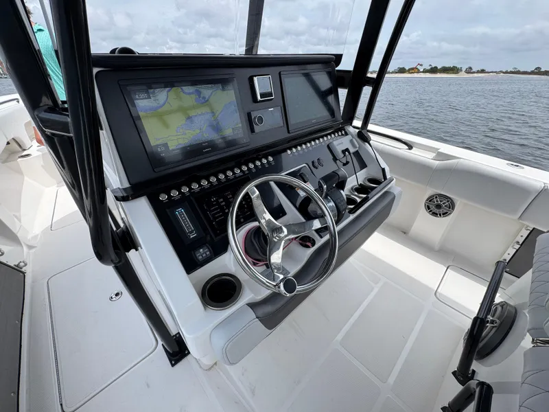 Slide: The Image of 2022 Fountain 38TE boat dashboard with navigation system and steering wheel. - 29