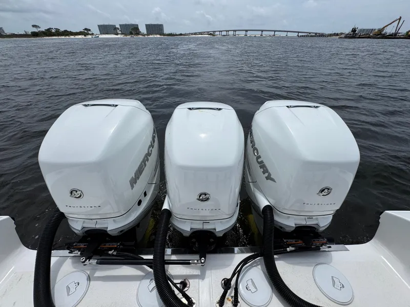 Slide: The Image of Triple Mercury outboard engines on a 2022 Fountain 38TE boat, cruising on open water. - 39