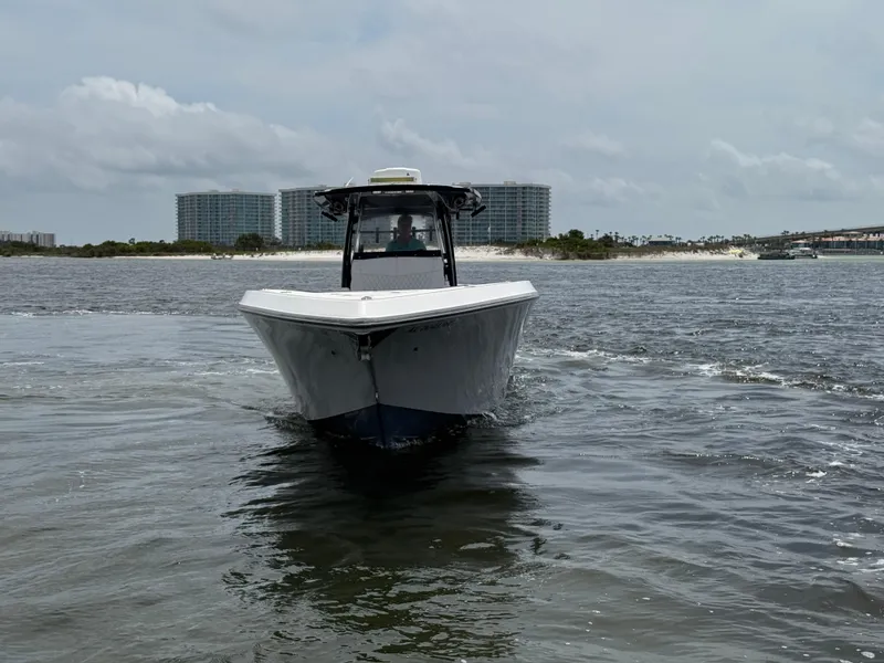 Slide: The Image of 2022 Fountain 38TE boat cruising on water with buildings in the background. - 7
