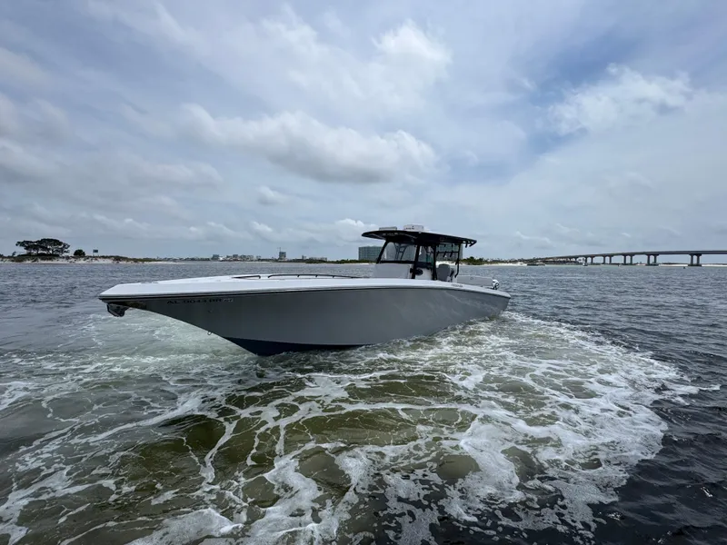 Slide: The Image of 2022 Fountain 38TE boat cruising on open water under cloudy skies. - 8