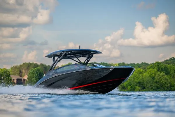 Slide: The Image of 2025 Yamaha Boats 275 SD cruising on a lake with scenic background. - 1