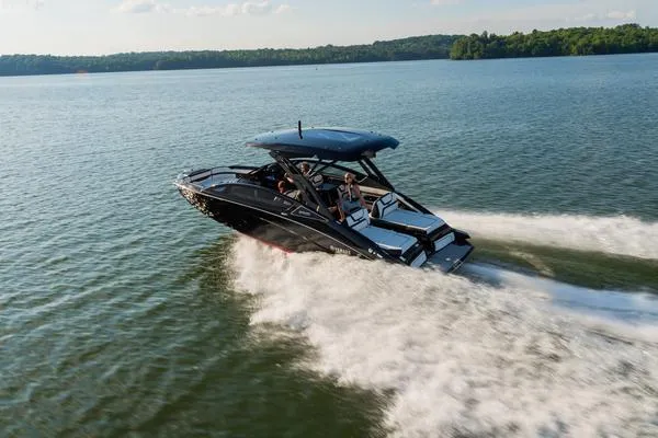 Slide: The Image of 2025 Yamaha Boats 275 SD cruising on a serene lake under a clear sky. - 3