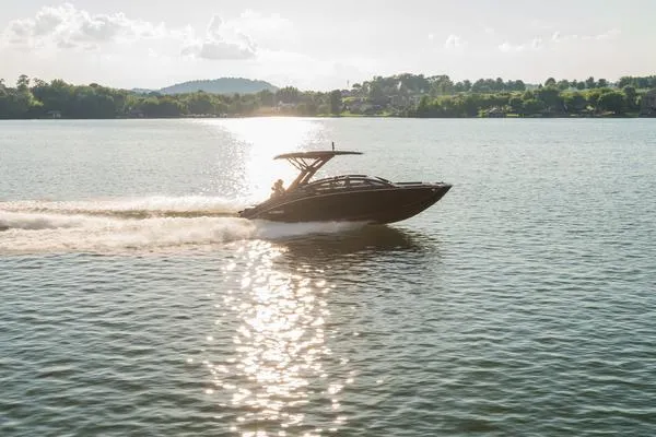 Slide: The Image of 2025 Yamaha Boats 275 SD cruising on a sunlit lake. - 8