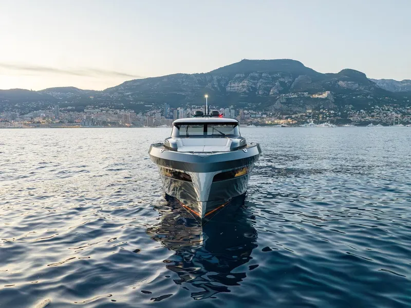Slide: The Image of 2026 Bekkers Yachts AZUR 45HT outboard on serene water with mountainous backdrop. - 6