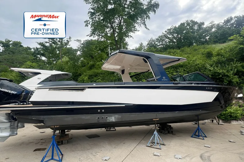 Slide: The Image of A 2022 Aviara AV36 OB boat on stands, surrounded by trees. - 0
