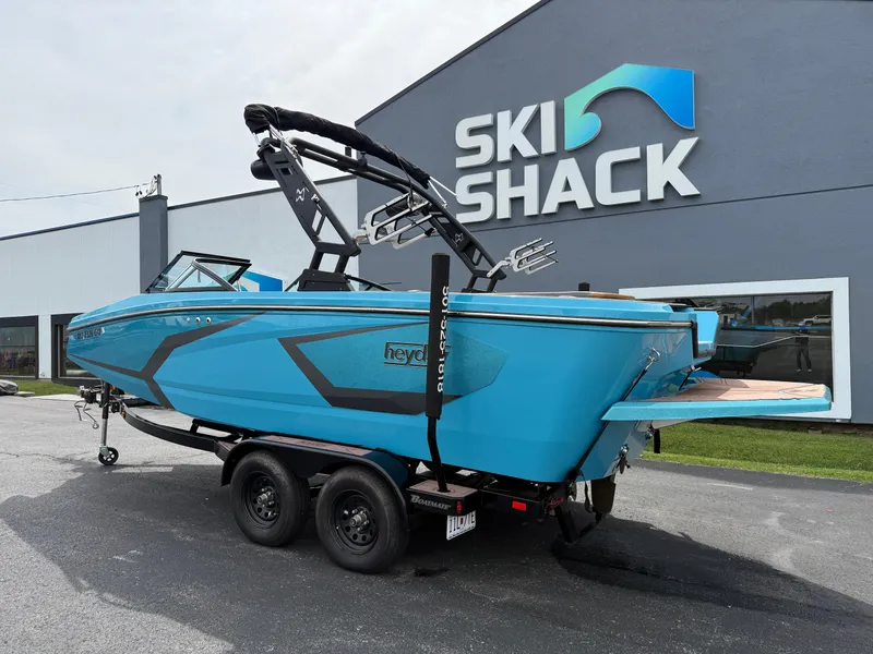 Slide: The Image of 2022 Heyday WT-2DC boat in blue, parked outside Ski Shack building. - 10