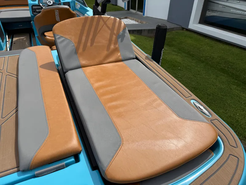 Slide: The Image of 2022 Heyday WT-2DC boat seat with tan and gray upholstery, outdoor setting. - 13