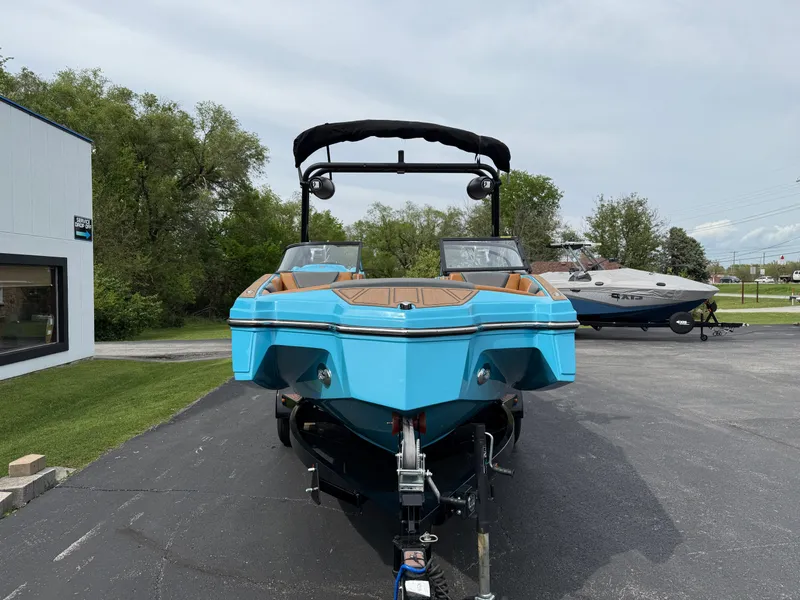 Slide: The Image of 2022 Heyday WT-2DC boat in vibrant blue, parked outdoors on a trailer. - 2