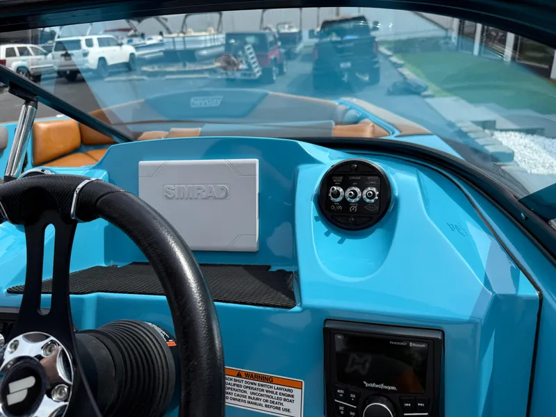 Slide: The Image of 2022 Heyday WT-2DC boat dashboard with steering wheel, Simrad display, and control panel. - 20