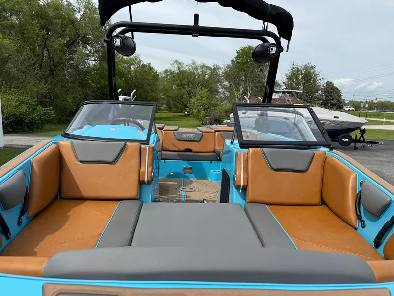 Slide: The Image of 2022 Heyday WT-2DC boat interior with tan and gray seating, blue accents, and open cockpit. - 22