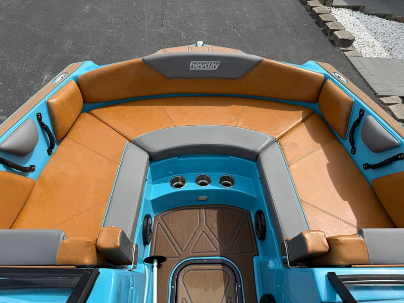 Slide: The Image of 2022 Heyday WT-2DC boat interior with tan and gray seating, blue accents. - 23