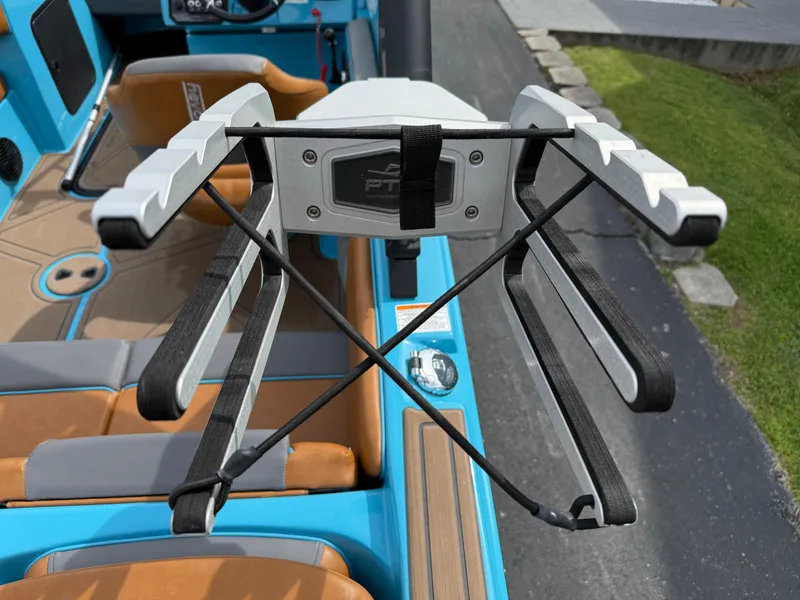 Slide: The Image of 2022 Heyday WT-2DC boat interior with wakeboard rack, blue and tan seating. - 26