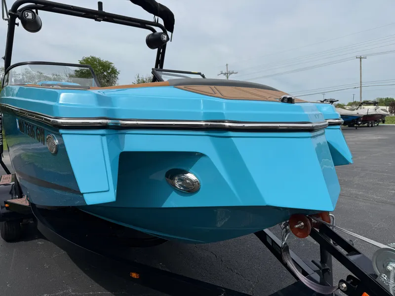 Slide: The Image of 2022 Heyday WT-2DC boat in vibrant blue on a trailer, parked outdoors. - 3