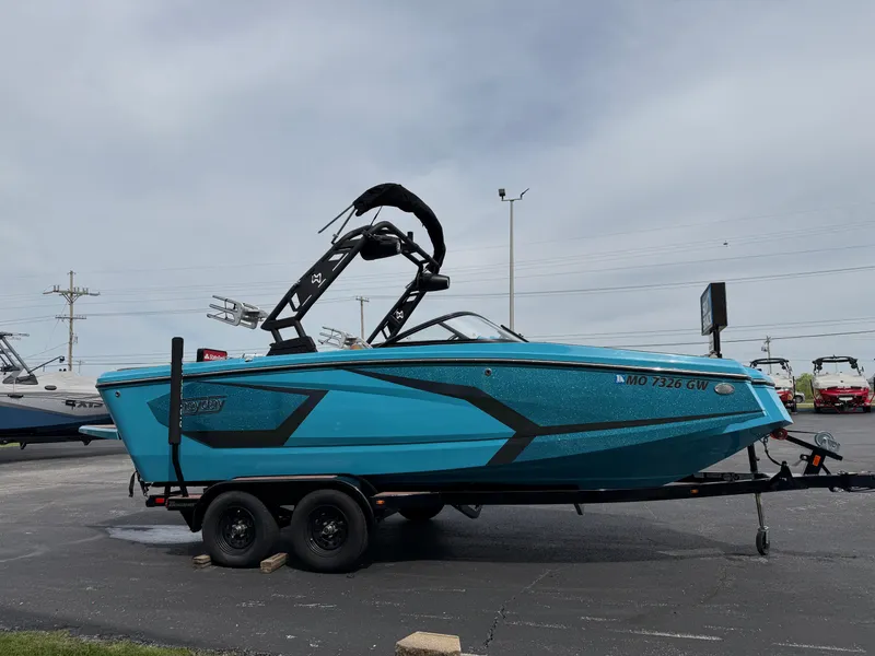 Slide: The Image of 2022 Heyday WT-2DC boat in vibrant blue on a trailer, parked outdoors. - 4