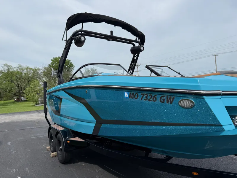 Slide: The Image of 2022 Heyday WT-2DC boat in blue on a trailer, parked outdoors. - 6