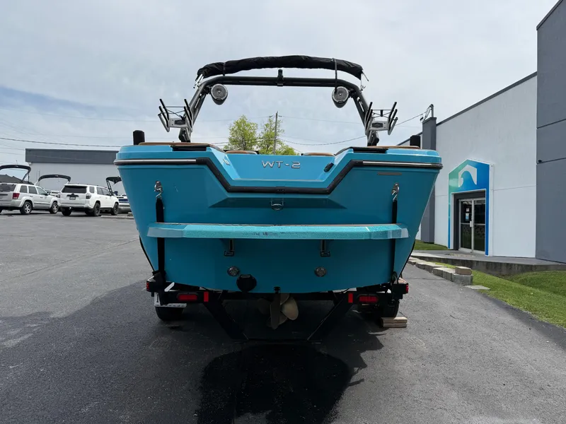 Slide: The Image of 2022 Heyday WT-2DC boat, rear view, parked on asphalt near a building. - 8