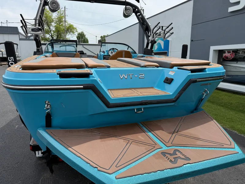 Slide: The Image of 2022 Heyday WT-2DC boat, blue exterior, rear view, docked outdoors. - 9