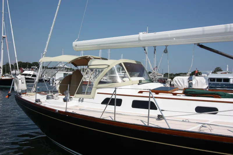 Slide: The Image of Hinckley Sou'wester 51 sailboat, 1993 model, docked in a marina under clear skies. - 10