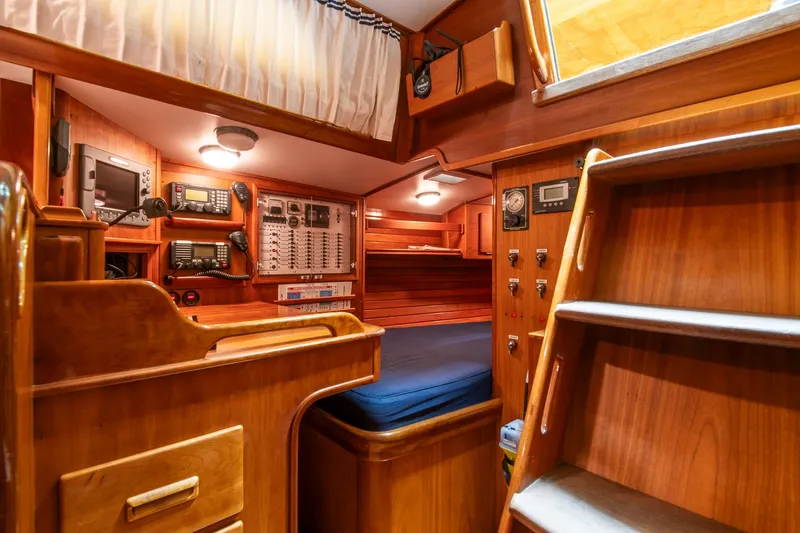 Slide: The Image of Hinckley Sou'wester 51 yacht interior, 1993 model, featuring navigation equipment and wooden cabinetry. - 17