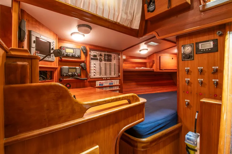 Slide: The Image of 1993 Hinckley Sou'wester 51 yacht interior with navigation equipment and wooden cabinetry. - 19