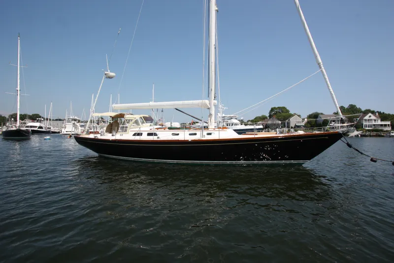 Slide: The Image of 1993 Hinckley Sou'wester 51 sailboat docked in a marina under clear skies. - 2