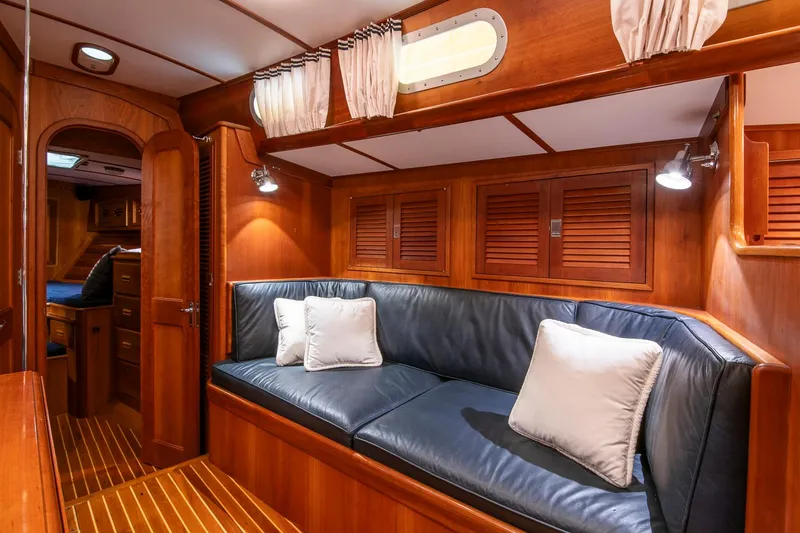 Slide: The Image of Luxurious 1993 Hinckley Sou'wester 51 yacht interior with wooden paneling and leather seating. - 27