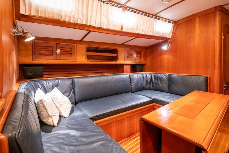 Slide: The Image of Luxurious interior of 1993 Hinckley Sou'wester 51 yacht with blue leather seating and wooden finishes. - 28