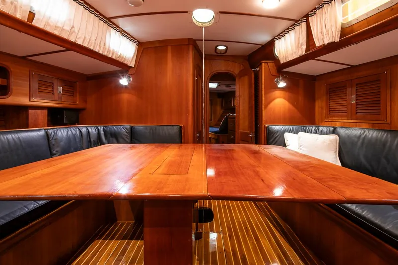 Slide: The Image of Luxurious wooden interior of 1993 Hinckley Sou'wester 51 yacht with elegant seating and lighting. - 31