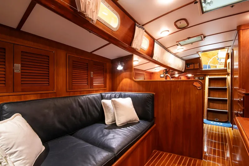 Slide: The Image of Luxurious interior of 1993 Hinckley Sou'wester 51 yacht with wooden finishes and cozy seating. - 34