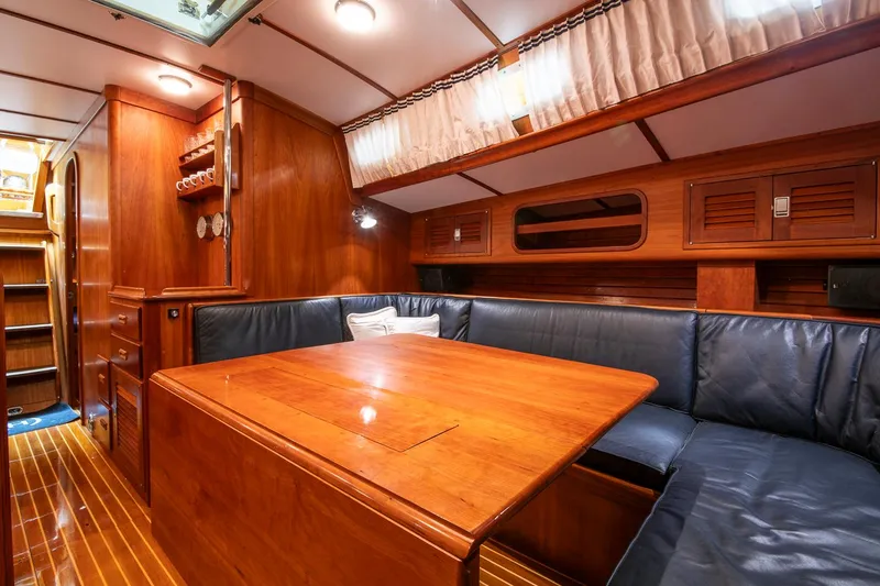 Slide: The Image of Luxurious wooden interior of 1993 Hinckley Sou'wester 51 yacht with cozy seating area. - 35