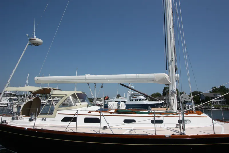 Slide: The Image of Hinckley Sou'wester 51 sailboat, 1993 model, docked at a marina under clear blue skies. - 9