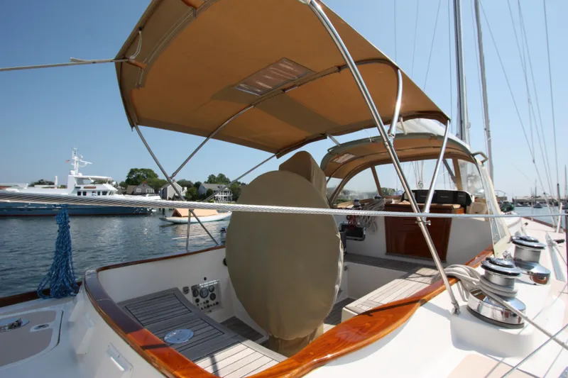 Slide: The Image of Hinckley Sou'wester 51 sailboat, 1993 model, featuring a spacious deck and canopy in a marina setting. - 16