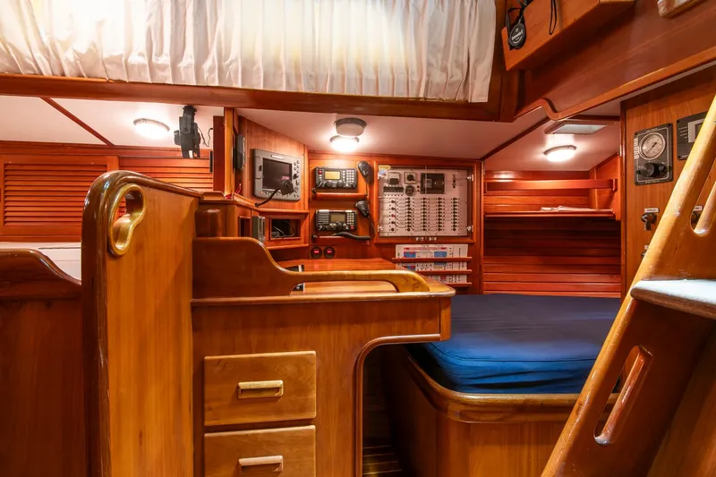 Slide: The Image of Hinckley Sou'wester 51 yacht interior, 1993 model, featuring navigation station and cozy wooden cabin. - 18