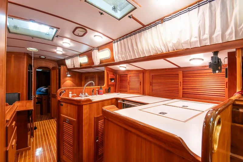 Slide: The Image of Luxurious interior of 1993 Hinckley Sou'wester 51 yacht with wooden cabinetry and modern amenities. - 22