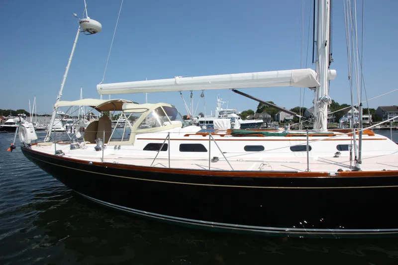 Slide: The Image of 1993 Hinckley Sou'wester 51 sailboat docked in a marina under clear blue skies. - 3