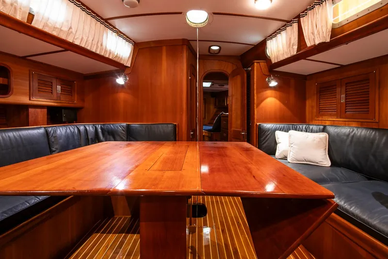 Slide: The Image of Luxurious interior of 1993 Hinckley Sou'wester 51 yacht with wooden table and leather seating. - 30