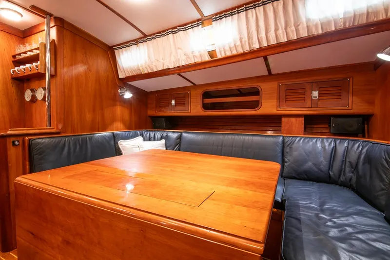 Slide: The Image of Luxurious wooden interior of 1993 Hinckley Sou'wester 51 yacht with blue leather seating. - 36