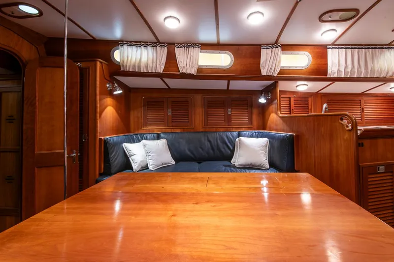 Slide: The Image of Luxurious interior of 1993 Hinckley Sou'wester 51 yacht with wooden finishes and cozy seating. - 37