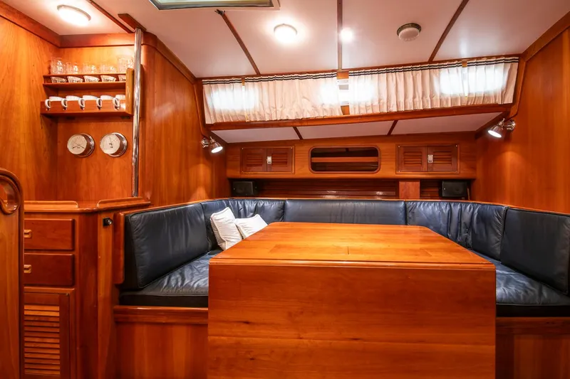 Slide: The Image of Luxurious wooden interior of 1993 Hinckley Sou'wester 51 yacht with cozy seating area. - 38