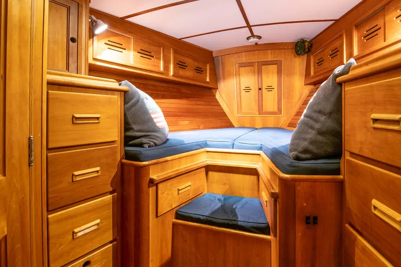 Slide: The Image of Cozy wooden cabin interior of 1993 Hinckley Sou'wester 51 sailboat with blue cushions. - 39