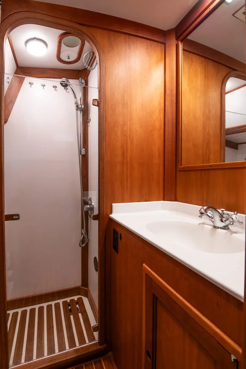 Slide: The Image of Hinckley Sou'wester 51 yacht bathroom, 1993 model, featuring wooden cabinetry and a shower. - 47