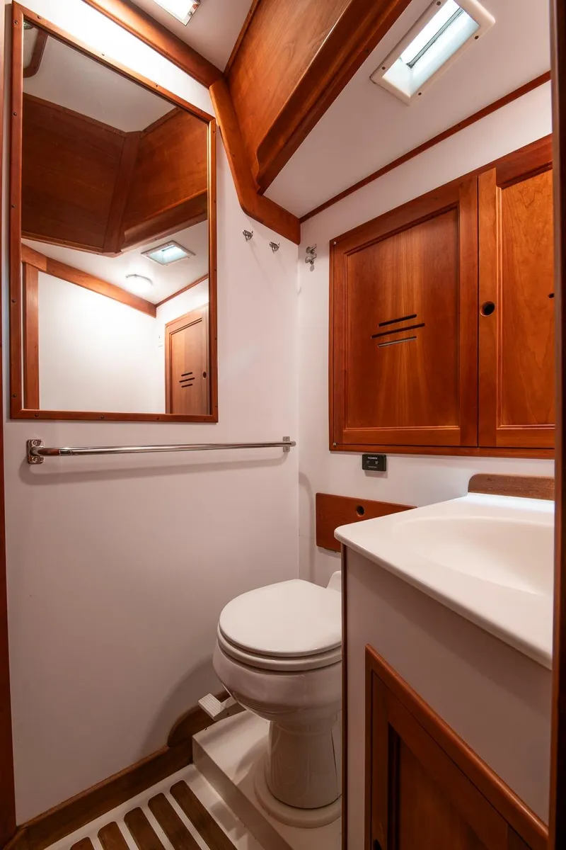 Slide: The Image of Hinckley Sou'wester 51 yacht bathroom, 1993 model, featuring wooden cabinetry and modern fixtures. - 49