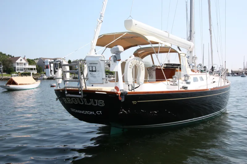 Slide: The Image of Hinckley Sou'wester 51 sailboat, 1993 model, docked in a serene marina setting. - 5