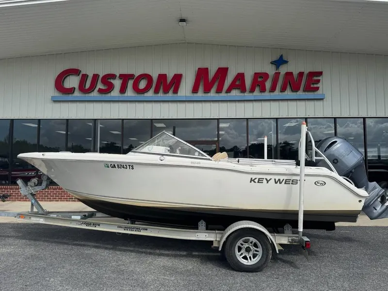 Slide: The Image of 2016 Key West 203 DFS boat on trailer outside Custom Marine store. - 0