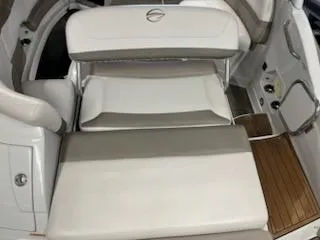 Slide: The Image of 2016 Crownline E4 boat interior with white seating and wood flooring. - 14