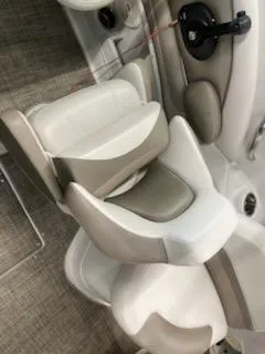 Slide: The Image of 2016 Crownline E4 boat interior with beige and white seating. - 17