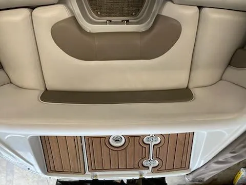 Slide: The Image of 2016 Crownline E4 boat interior with cushioned seating and wooden deck details. - 2