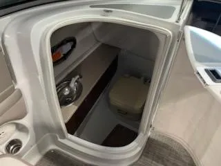 Slide: The Image of 2016 Crownline E4 boat interior with compact bathroom and sink. - 20