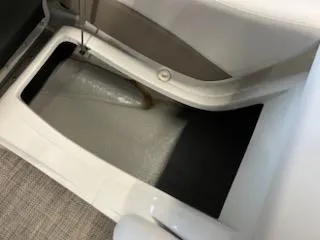 Slide: The Image of 2016 Crownline E4 boat storage compartment with white interior and carpeted flooring. - 21