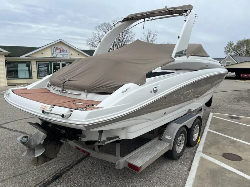 Slide: The Image of 2016 Crownline E4 boat on trailer, covered, parked in a lot. - 22